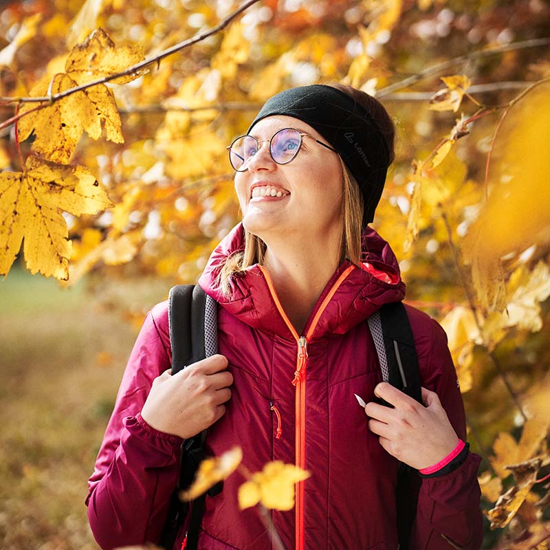Wanderin zwischen herbstlichen bunten Bäumen
